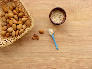 Wall Mural - inshell almonds and almond flour in a clay bowl