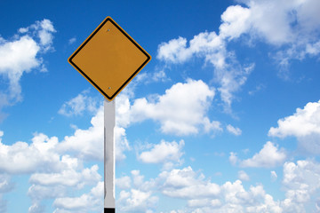 Blank yellow road sign on blue sky and clouds