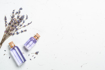 Fototapete - Lavender essential oil on white.