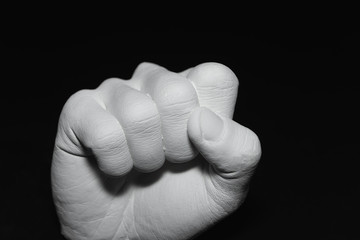 gypsum fist on the black background