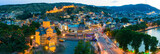 Fototapeta  - The evening panorama of the old town in the old district of Avlabari, Holy Trinity Cathedral and Rike Park, the Kura river reflects the evening city lights in Tbilisi, Georgia.