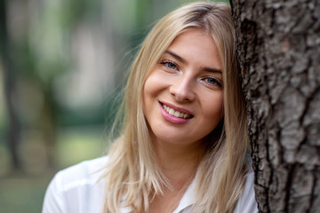 Wall Mural - Portrait of young blonde girl in park