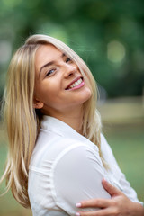 Wall Mural - Portrait of young blonde girl in park