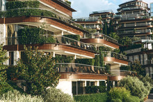 View Of A Modern Hotel In Budva In Montenegro With Many Windows And Balconies And Plants.