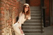 © ElenaBatkova - Model young girl with beautiful face on brick wall background.