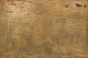 rusty golden metal surface with yellow and orange tones - worn steampunk background with screws and scratches