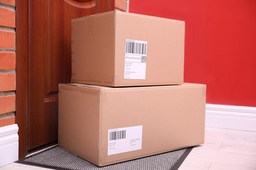 Poster - Parcels on rug near door. Delivery service