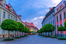 Cobblestone Street Road With Colorful Multicolored Buildings And Green Trees In Old Town Historical City Centre, Evening View, Ostrow Tumski, Wroclaw, Poland