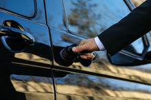 Driver Opening Door Of Luxury Car, Closeup. Chauffeur Service