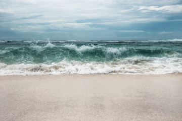 Wall Mural - Sea beach big surf wave turquoise water blue dramatic sky landscape 