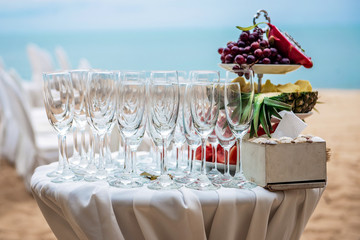 Wedding ceremony on the beach. Fruit buffet and glasses for shompan