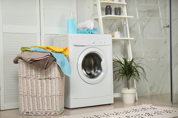 Wall Mural - Wicker basket with laundry and washing machine in bathroom