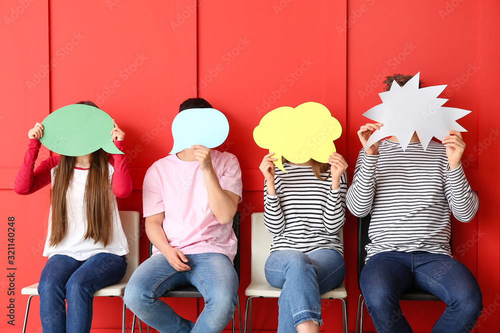 Group of young people with blank speech bubbles on color background