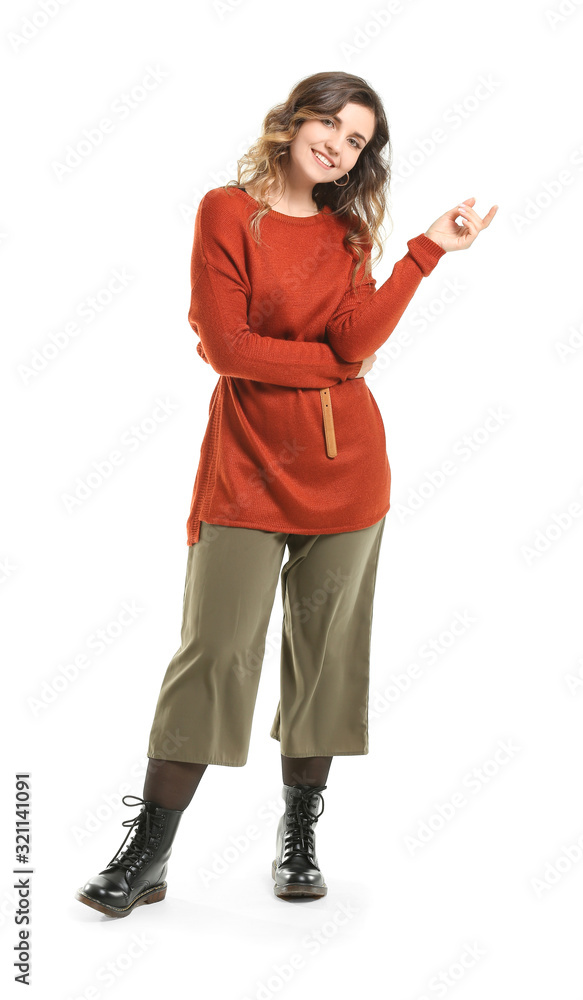Beautiful young woman in warm sweater on white background