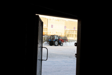 view through open door on tractor removes snowCold winter