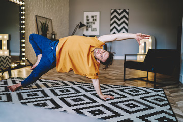 Fototapete - Focused man practising yoga in flat
