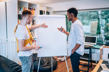 Sticker - Multiethnic colleagues discussing data from flip chart