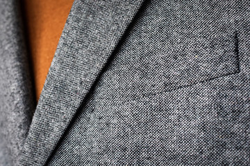 Wall Mural - Close up of mens grey wool blazer combined with brown fashionable sweater.  Low DOF. Selective focus.