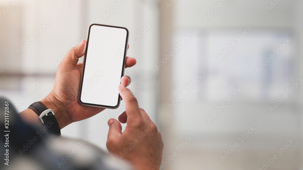 Close up view of a man using blank screen smartphone - obrazy, fototapety, plakaty 