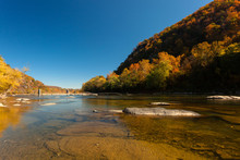 The Crystal Clear Water Of The  Potomac River In Harper's Ferry, West Virginia, On A Sunny Day With Colorful Foliage On Trees
