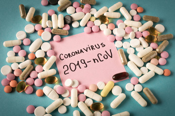 Coronavirus. Sticker with the inscription coronavirus and a scattering of pills on a blue background. The concept of virus protection.