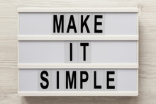'Make It Simple' Words On A Lightbox On A White Wooden Background, Top View. Overhead, From Above, Flat Lay. Close-up.