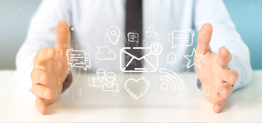 Businessman holding a cloud of social media network icon