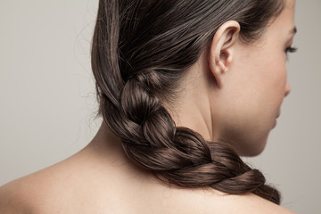 closeup of wet woman hair in braid studio shot rear view focus on hair