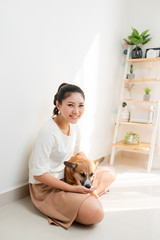 Wall Mural - Portrait of woman with Corgi dog at home, indoor.  Lifestyle concept