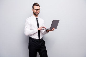 Poster - Strict focused real estate agent boss man hold laptop use modern technology work on his project workshop training wear white shirt black pants trousers isolated grey color background