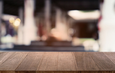 Empty dark wooden table in front of abstract blurred bokeh background of restaurant . can be used for display or montage your products.Mock up for space.