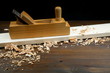 wooden planer with wood shavings on a wooden surface