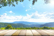 Wooden table against mountain, hill, blurry background.