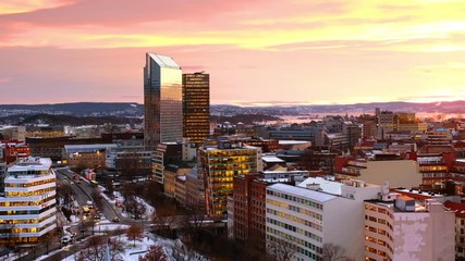 Poster - Oslo, Norway. A night view of Sentrum area of Oslo, Norway, with modern and historical buildings and car traffic. Sunset colorful sky in winter with snow, zoom out