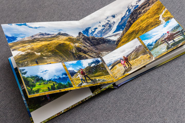 Wall Mural - Photobook album on deck table with travel photos