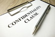 Confidentiality clause with pen on desk