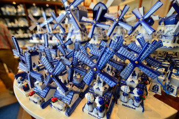 Wall Mural - Delft, the netherlands, august 2019. At a shop of the famous white and blue ceramics of miniature windmills to buy as a souvenir.