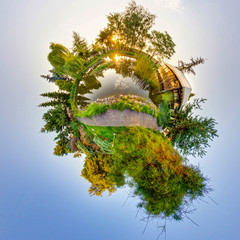 Green Little Planet Earth with trees and soft blue sky. Tiny planet sunset. 360 viewing angle. Spherical Panorama