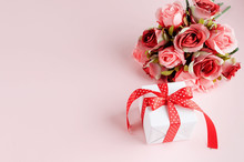 Gift Box With Bouquet Of Tred Rose On Pastel Pink Background