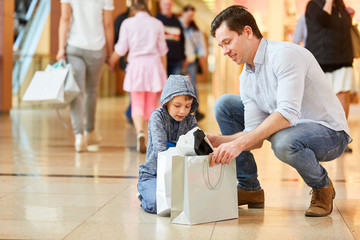 Father and son unpack grocery bag