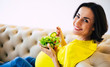 © My Ocean studio - Healthy diet while pregnant. Attractive pregnant woman looks in the camera and smiles while eating fresh green salad.