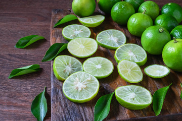 Fresh ripe limes on wooden background