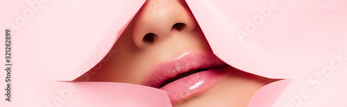 cropped view of woman showing pink lips in torn paper, panoramic shot Tableau sur Toile