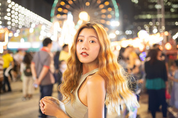 Traveler Asian blogger women travel in Bangkok, Thailand, beautiful female using .Beautiful smiling tourist young  woman having fun at amusement park at hot summer day trip.