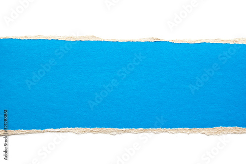 Blue torn stripe of cardboard paper on white background. Copy space for text message. © Purple Moon