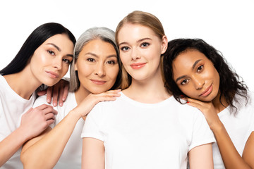 Wall Mural - cheerful multicultural women in white t-shirts looking at camera isolated on white