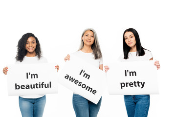 Wall Mural - happy multicultural women holding posters with lettering isolated on white