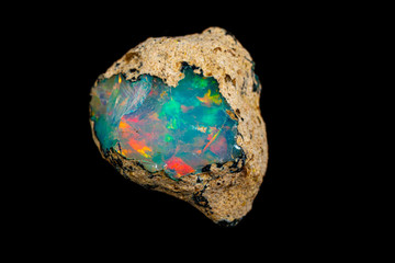 Wall Mural - macro mineral stone rare and beautiful opals on a black background