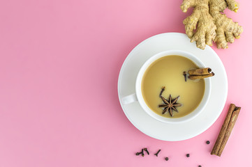 Traditional indian masala chai tea in white cup with spiced. With copy space.