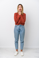 Wall Mural - Full body young caucasian woman praying for luck, amazed and opening mouth looking to front.